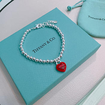 Fortok Tiffany & Co. Return to Tiffany Heart Tag Toggle Bracelet in silver with a red heart tag 